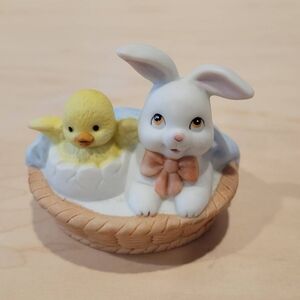 Ceramic bunny and chick in a basket. Easter bunny with chick